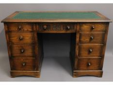 A 20thC. oak desk with nine drawers, 30.25in high