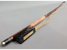 A 19thC. violin bow, 29in long, strings a/f