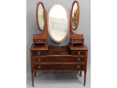 An Edwardian mahogany dressing table with six draw