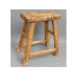 An 18th/19thC. rustic farm house stool, possibly elm & walnut/fruitwood 19in high
