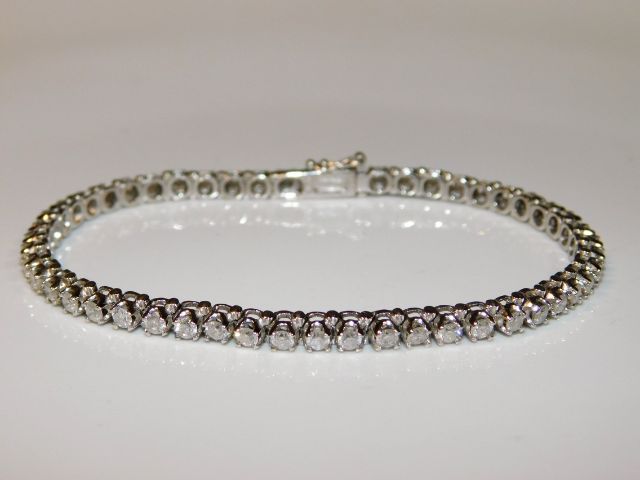 An 18ct white gold tennis bracelet set with approx