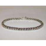 An 18ct white gold tennis bracelet set with approx