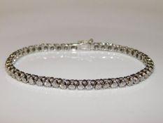 An 18ct white gold tennis bracelet set with approx