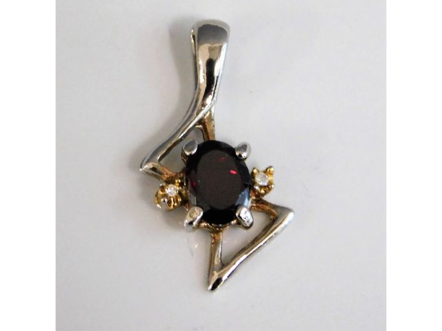 A two colour 9ct gold (tested) garnet & white ston