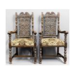 A pair of upholstered matching heavily carved oak