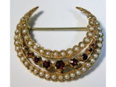 A 9ct gold crescent shaped brooch set with seed pe