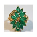 A 14ct gold ring set with marquise cut emeralds &