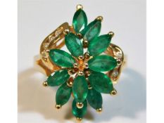 A 14ct gold ring set with marquise cut emeralds &