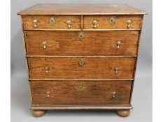 An oak William & Mary chest of drawers on bun feet