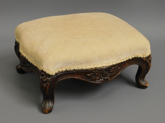 A Victorian upholstered mahogany foot stool with c