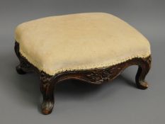 A Victorian upholstered mahogany foot stool with c