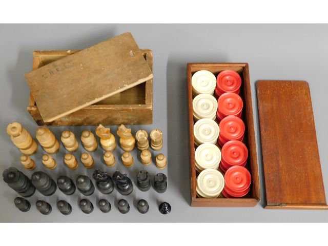 A set of Victorian bone draughts set twinned with