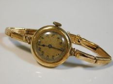 A ladies 14ct gold case & strap wrist watch, 18.7g