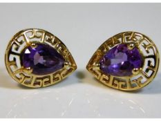 A pair of 9ct gold earrings set with pear cut amet