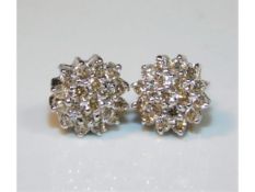 A pair of 18ct gold earrings set with approx. 0.5c