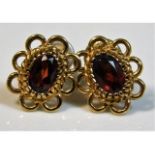 A pair of 9ct gold earrings set with garnets, 1.6g