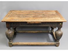 A 16thC. Elizabethan draw leaf oak refectory table with fruit & vine carving to legs (extensions not