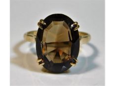 A 9ct gold ring set with smokey quartz stone, size
