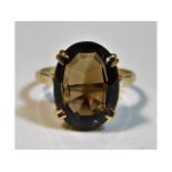 A 9ct gold ring set with smokey quartz stone, size