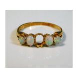 An antique 18ct gold ring set with opals, one miss