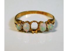 An antique 18ct gold ring set with opals, one miss