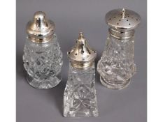 Three early 20thC. silver topped glass sugar caste