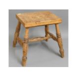 An early 20thC. oak stool with turned legs, 13.75in high