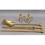 A brass companion set twinned with two brass fire