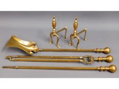 A brass companion set twinned with two brass fire