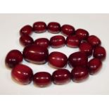 A large set of vintage cherry amber style beaded necklace, largest bead, 23in long, 1.625in wide, 21