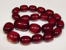 A large set of vintage cherry amber style beaded necklace, largest bead, 23in long, 1.625in wide, 21