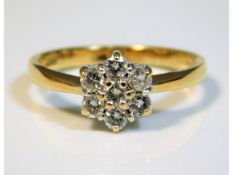 An 18ct gold seven stone daisy style ring set with