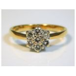 An 18ct gold seven stone daisy style ring set with