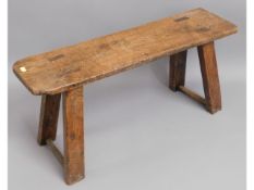 A 19thC. elm joint bench, 29.5in wide x 13.75in hi