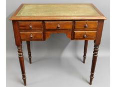 A 1920's mahogany lowboy with ringed tapered legs,