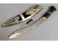 A modern Kukri knife with white metal decor to she