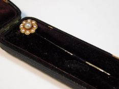 A cased yellow metal stick pin set with natural pe