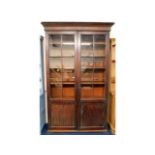 A 19thC. mahogany bookcase, crack to one glass, tw