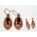 A pair of pink gold drop earrings set with garnets