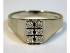 An 18ct white gold ring set with six diamonds, siz