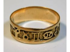 A yellow metal ring with signs of Zodiac design, size R, 2.2g, tests as 14ct gold