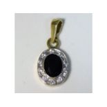 A 9ct gold pendant set with diamond & sapphire, 11