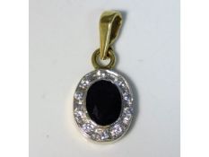 A 9ct gold pendant set with diamond & sapphire, 11