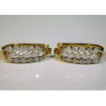 A pair of 10ct gold earrings set with approx. 1ct