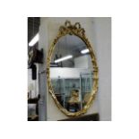 A Regency style gilt framed oval mirror, 40in high