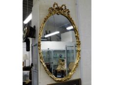 A Regency style gilt framed oval mirror, 40in high
