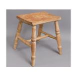 A 19thC. elm stool with turned legs, 13.5in high