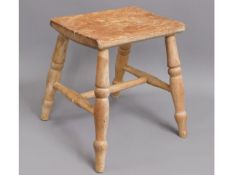 A 19thC. elm stool with turned legs, 13.5in high