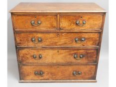 A George II walnut chest of drawers with brass fit