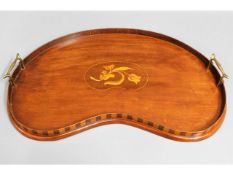 An Edwardian mahogany kidney shaped tray with bras